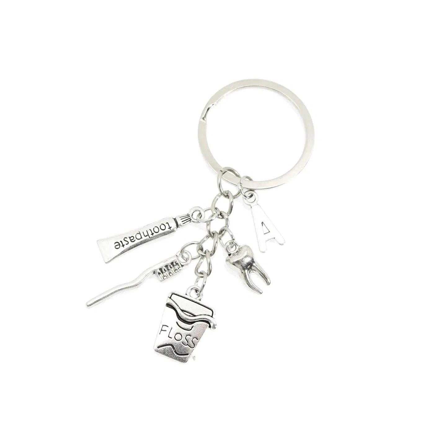 Porte-clés brosse à dents, fil dentaire, dentifrice et dent